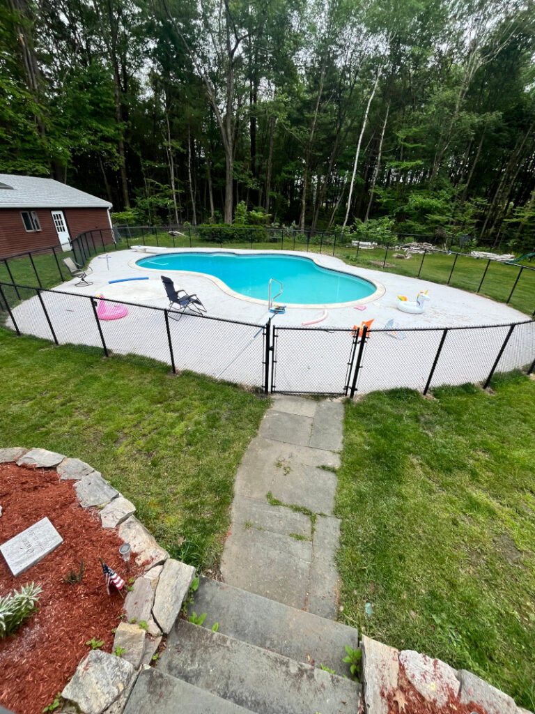 For this job in Londonderry, NH, we installed black chain link mini mesh around this beautiful pool! At Granite State Fence Company, quality pool fencing installed correctly for maximum safety at an affordable price is our goal.