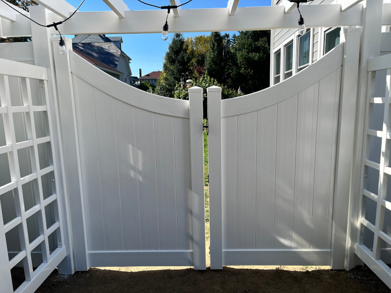 Vinyl Fencing with attached Pergola installed in Nashua, NH.