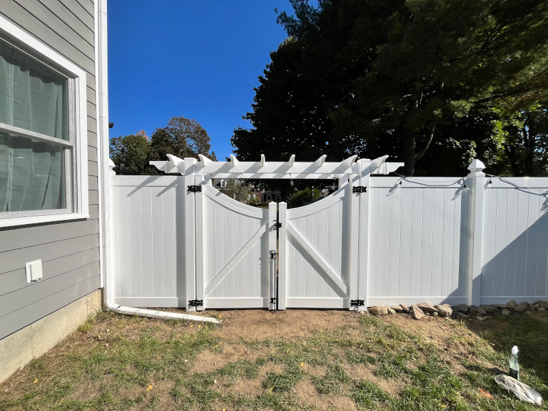 Vinyl Fencing with attached Pergola installed in Nashua, NH.