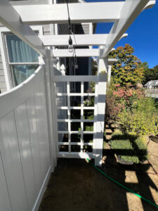 Vinyl Fencing with attached Pergola installed in Nashua, NH.