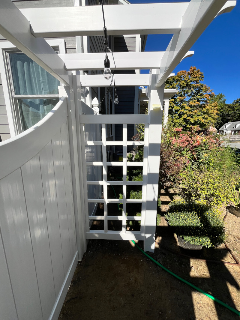 Vinyl Fencing with attached Pergola installed in Nashua, NH.