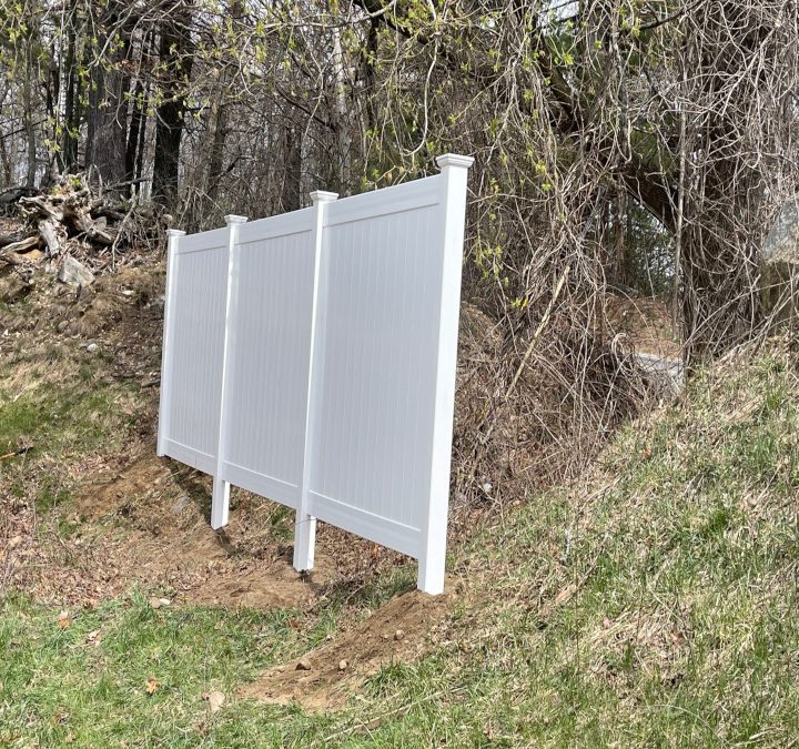 White Vinyl Privacy Fencing installation in Derry, NH.