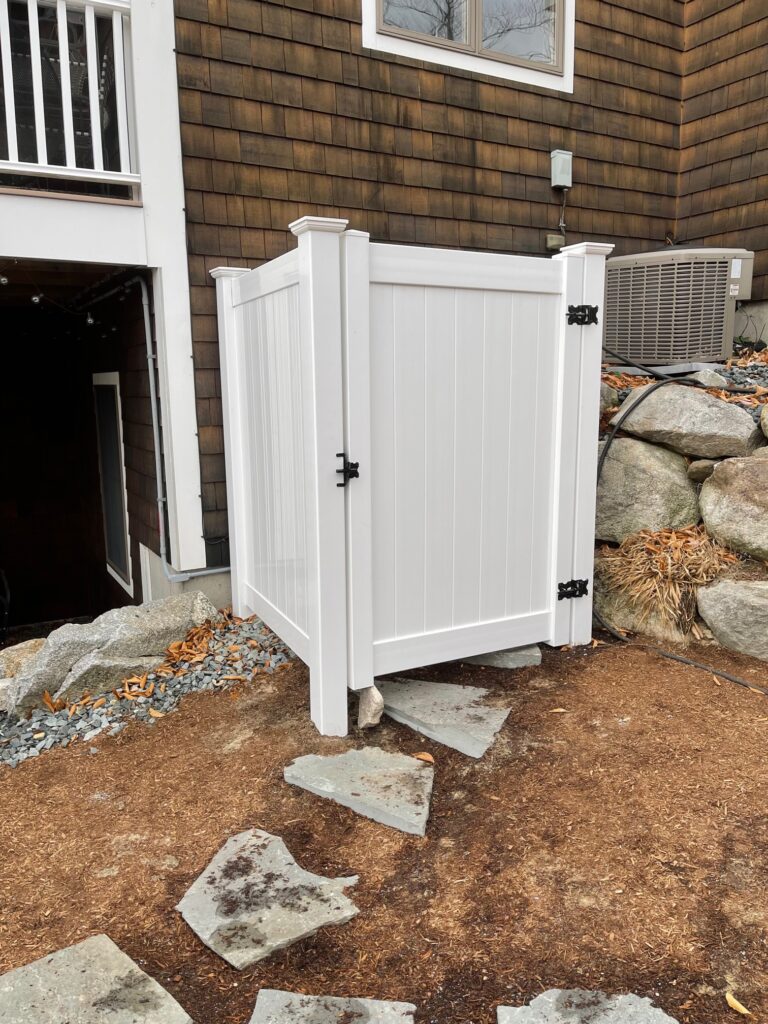 Granite State Fence fabricated and installed an enclosure using white vinyl for an outdoor shower in Newbury, NH. 