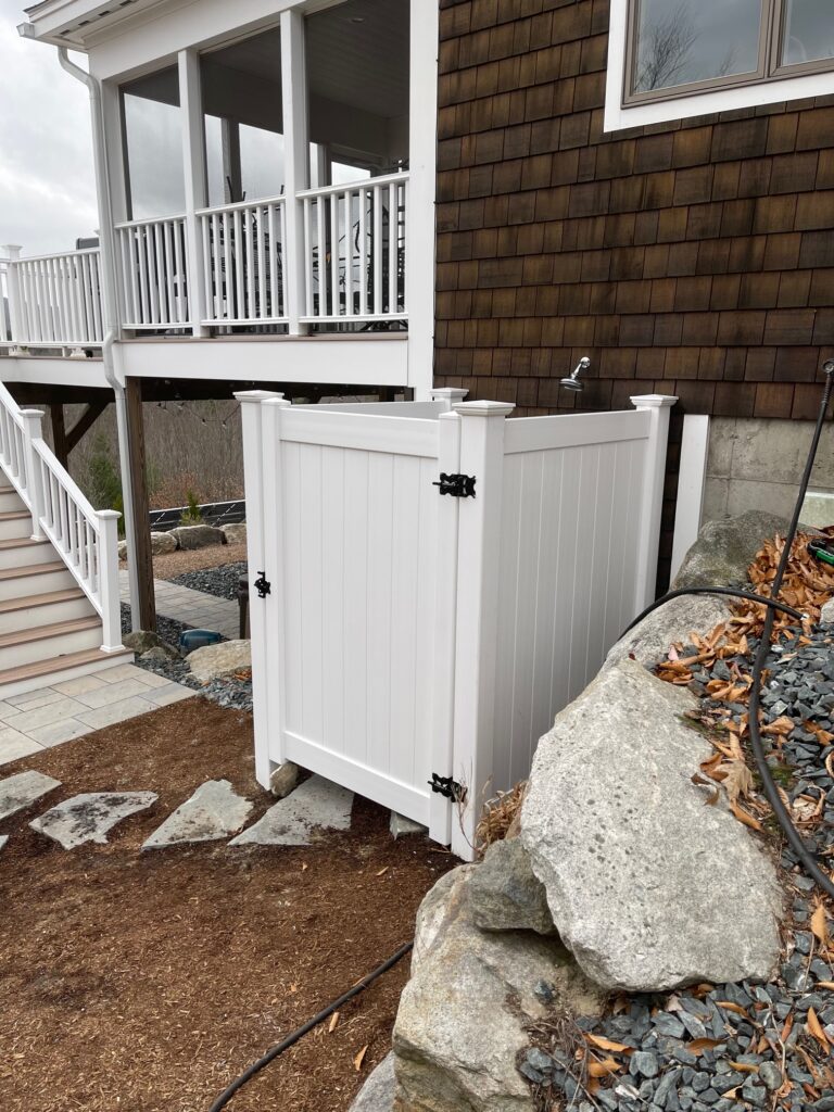 Granite State Fence fabricated and installed an enclosure using white vinyl for an outdoor shower in Newbury, NH. 