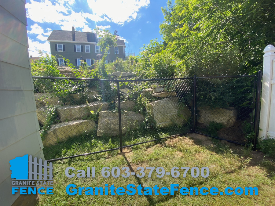 Black Vinyl Coated Chain Link Fence installed in Nashua, NH.