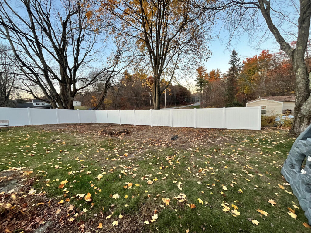 6’ white vinyl privacy fencing installed with a clean, consistent layout across the entire backyard.