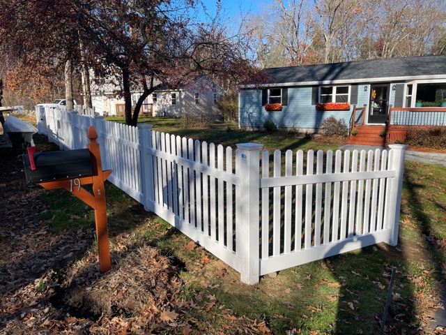 Granite State Fence installed a 4’ white dog ear picket vinyl fence for this property in Salem, NH.