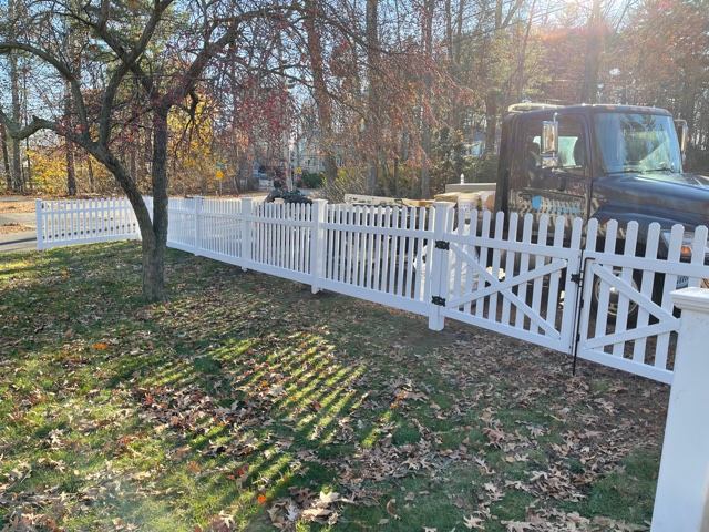 Granite State Fence installed a 4’ white dog ear picket vinyl fence for this property in Salem, NH.