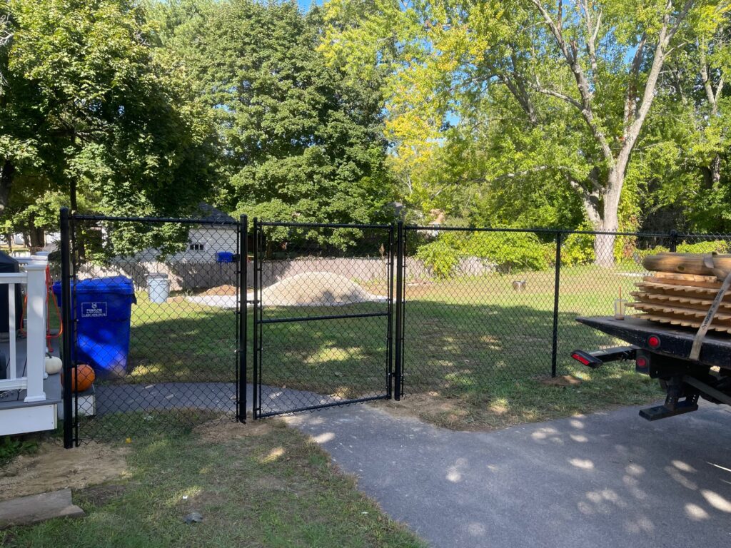 Granite State Fence installed a 6' chain link with tension wire for this yard in Hudson, NH.
