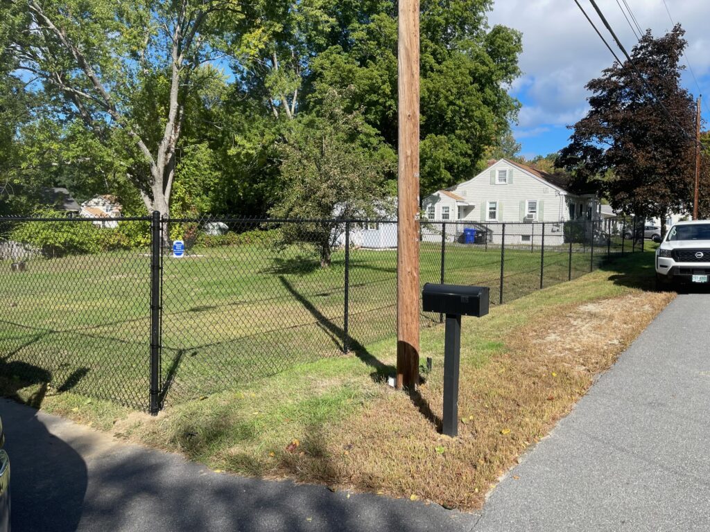 Granite State Fence installed a 6' chain link with tension wire for this yard in Hudson, NH.
