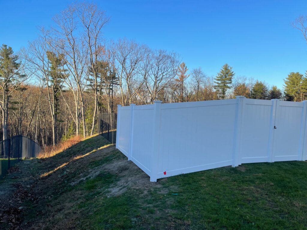 Granite State Fence installed both 6' white vinyl privacy fencing and 5' black chain Link fencing in the back for this residence in Hudson, NH.
