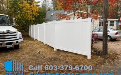 White Vinyl Privacy Fence installed between properties in Raymond, NH.