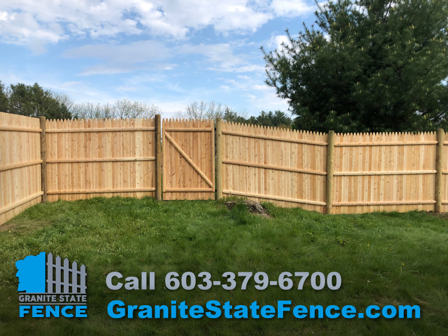 Our crew installed this cedar board panel fence with pressure treated posts.