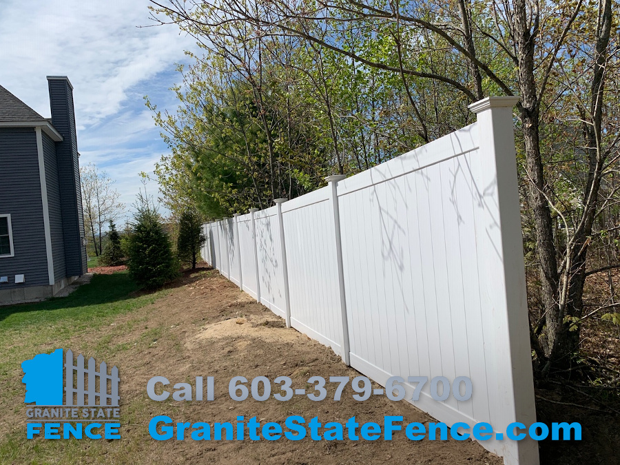 White Vinyl Privacy fence installed in Auburn, NH.