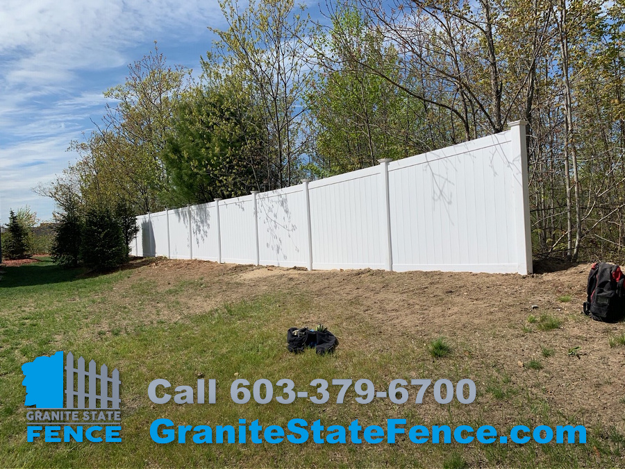 White Vinyl Privacy fence installed in Auburn, NH.