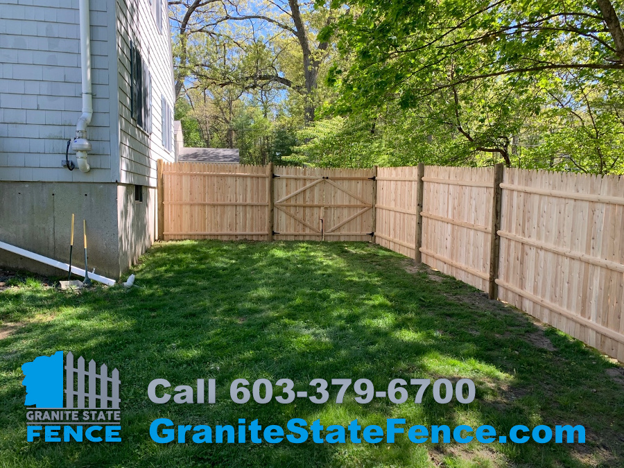 Cedar Stockade Privacy Fence and Chain Link Fence Installation in Chelmsford, MA.