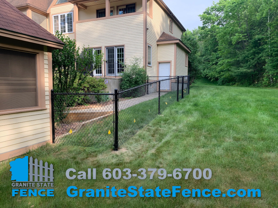 Black vinyl coated chain link fence installed in Windham, NH.