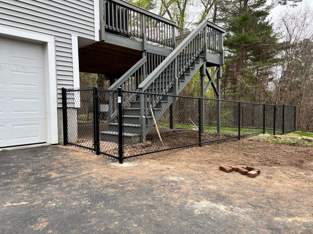 The crew from Granite State Fence installed 4' Chain Link fencing with bottom rail for this property in Hudson, NH.